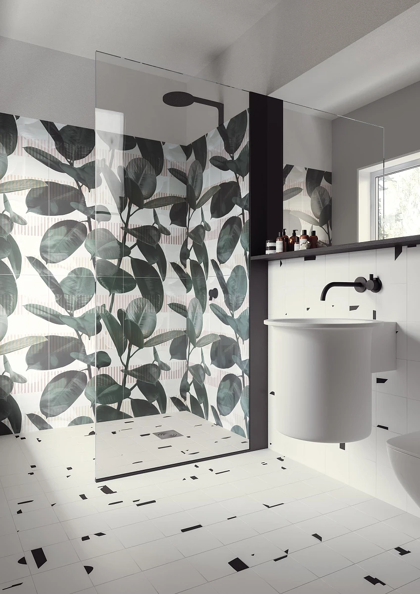 Aranżacja biało-czarnej łazienki, z płytkami z motywem liści w obrębie kabiny prysznicowej. 